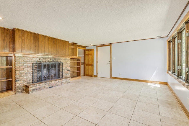 2000 191st Ave NW, Oak Grove, MN 55011 - unfurnished living room featuring a textured ceiling, light tile patterned flooring, a brick fireplace, baseboards, and built in features