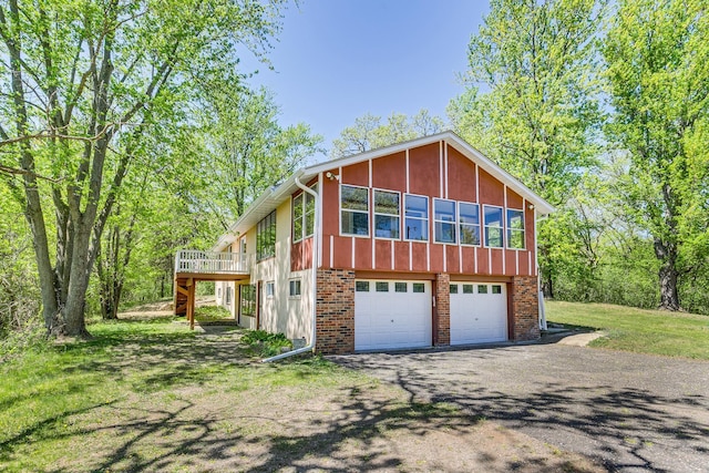 2000 191st Ave NW, Oak Grove, MN 55011 - view of front of house with an attached garage, asphalt driveway, and a deck