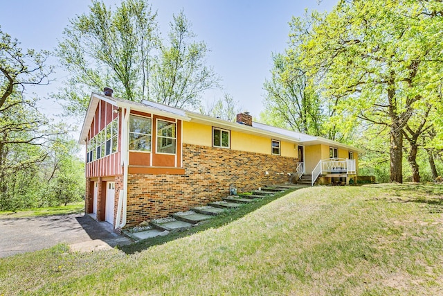 2000 191st Ave NW, Oak Grove, MN 55011 - single story home featuring a chimney, brick siding, an attached garage, asphalt driveway, and a front yard