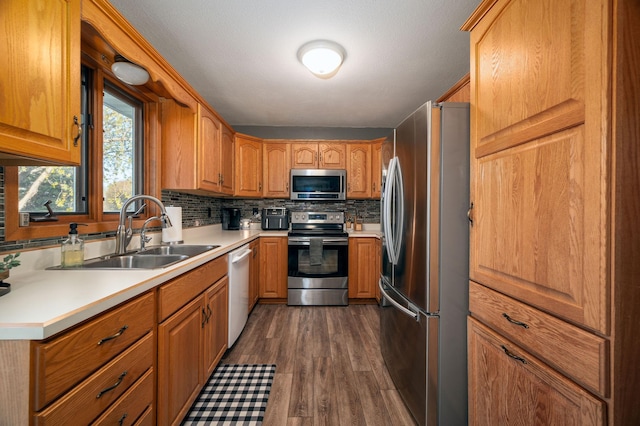 791 Highland Rd, Windom, MN 56101 - kitchen with stainless steel appliances, a sink, dark wood-style floors, tasteful backsplash, and light countertops