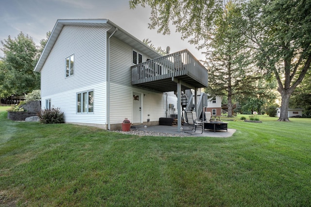 791 Highland Rd, Windom, MN 56101 - back of property with a patio area, a deck, stairs, a lawn, and a fire pit