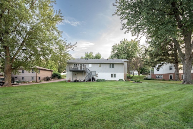 791 Highland Rd, Windom, MN 56101 - rear view of house featuring a lawn, stairs, and a wooden deck