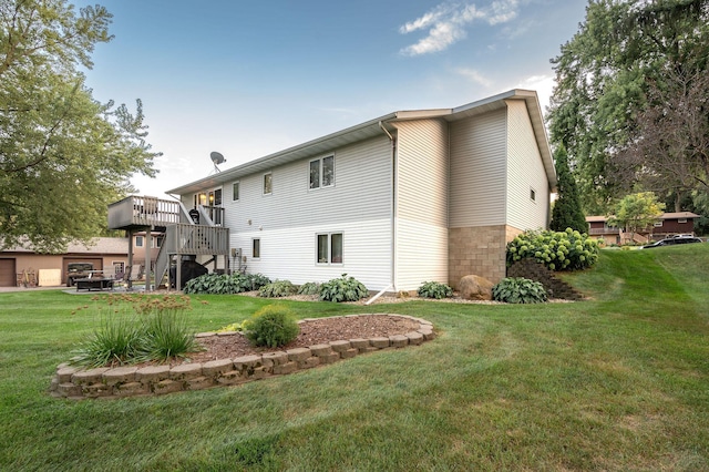 791 Highland Rd, Windom, MN 56101 - back of house with stairs, a wooden deck, and a lawn