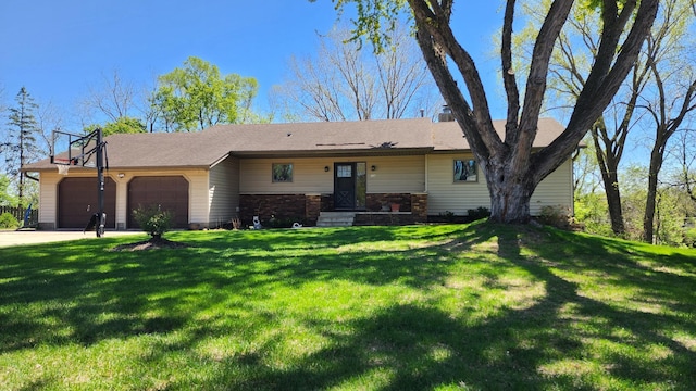 ranch-style house with a garage, a front lawn, and driveway