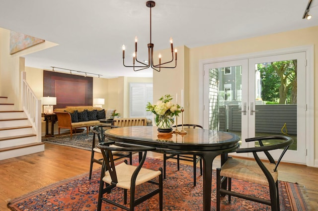 28 Greenway Gables, Minneapolis, MN 55403 - dining room featuring track lighting, wood finished floors, stairway, and french doors