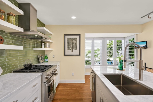 28 Greenway Gables, Minneapolis, MN 55403 - kitchen with appliances with stainless steel finishes, open shelves, tasteful backsplash, light stone counters, and wood finished floors