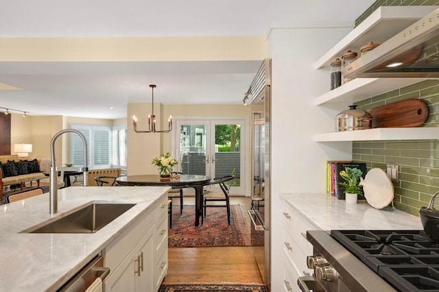 28 Greenway Gables, Minneapolis, MN 55403 - kitchen featuring light stone countertops, white cabinets, and open shelves