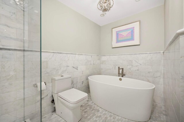 28 Greenway Gables, Minneapolis, MN 55403 - full bath featuring tile walls, a freestanding tub, and a wainscoted wall