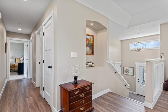 409 10th St NW, Dodge Center, MN 55927 - hall featuring an upstairs landing, dark wood-type flooring, baseboards, a chandelier, and recessed lighting
