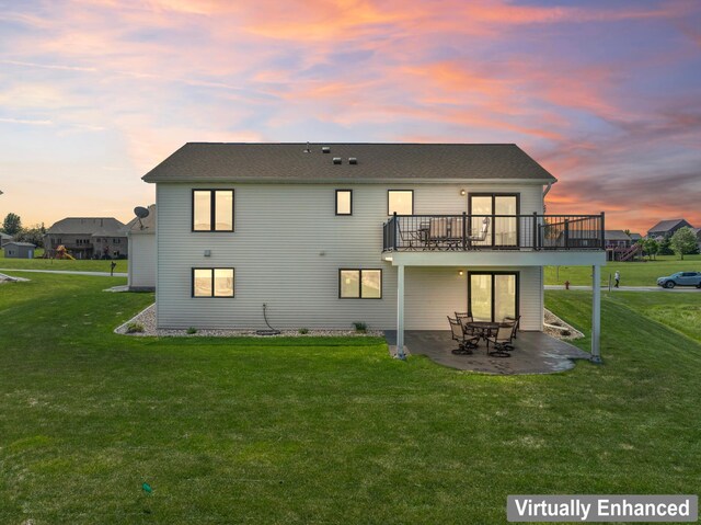 409 10th St NW, Dodge Center, MN 55927 - back of house at dusk with a lawn, a patio, and a deck