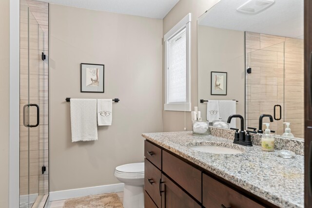 409 10th St NW, Dodge Center, MN 55927 - bathroom featuring baseboards, a stall shower, and vanity