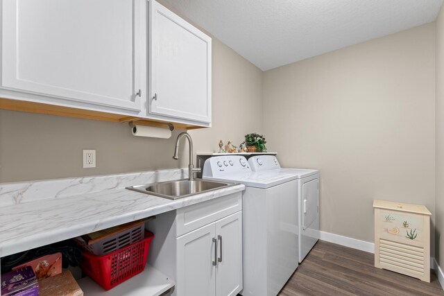 409 10th St NW, Dodge Center, MN 55927 - washroom featuring separate washer and dryer, cabinet space, dark wood-style floors, and baseboards