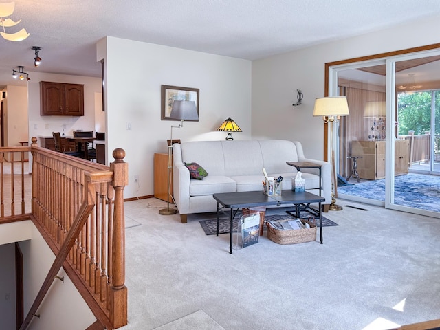 living room featuring light colored carpet and a textured ceiling