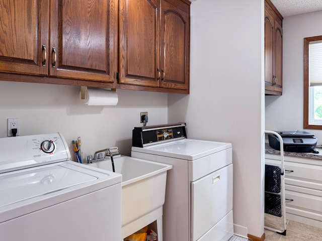 laundry room featuring independent washer and dryer, cabinet space, and light tile patterned flooring