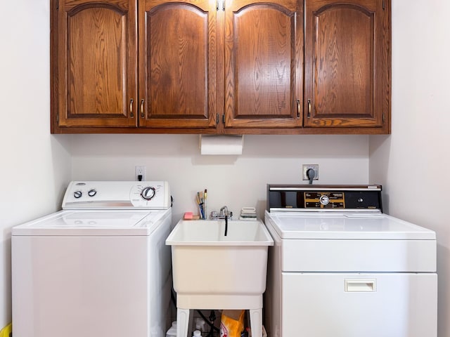 washroom with cabinet space and washing machine and clothes dryer