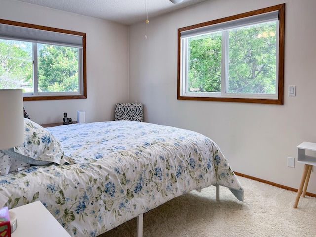 bedroom featuring carpet and baseboards