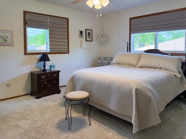 carpeted bedroom featuring a ceiling fan and baseboards
