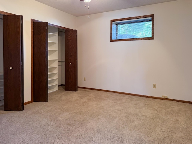 unfurnished bedroom with carpet floors and baseboards