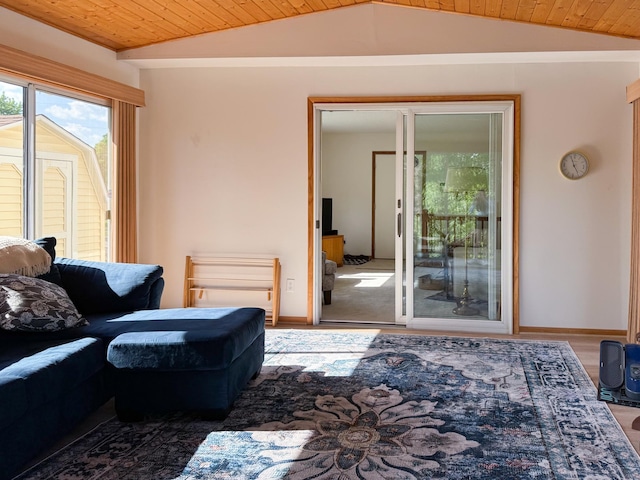 living room with lofted ceiling, wood ceiling, and baseboards