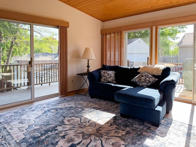 living room with lofted ceiling, healthy amount of natural light, wooden ceiling, and wood finished floors