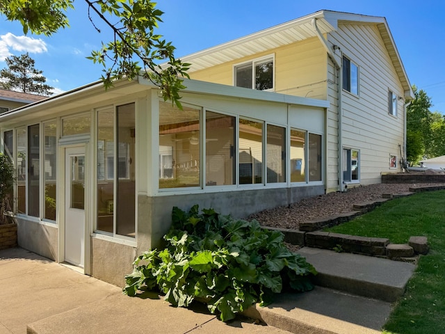 view of side of home with a sunroom