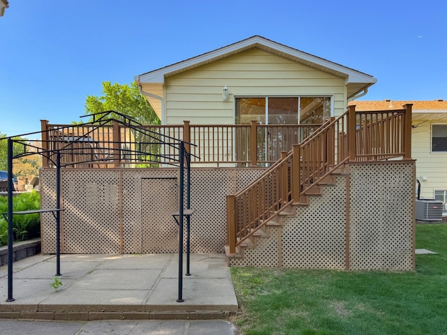 view of front of house featuring stairway, central air condition unit, a patio area, and a front yard