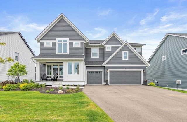 5068 Airlake Draw, Woodbury, MN 55129 - view of front facade featuring covered porch, driveway, a garage, a front lawn, and a shingled roof
