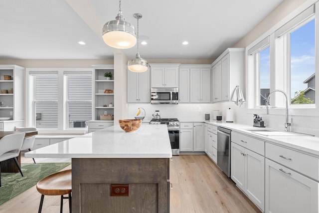5068 Airlake Draw, Woodbury, MN 55129 - kitchen with stainless steel appliances, a sink, open shelves, a center island, and backsplash
