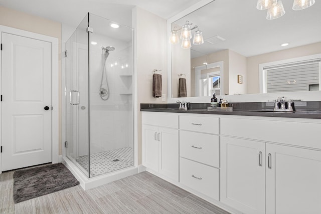 5068 Airlake Draw, Woodbury, MN 55129 - full bathroom with a shower stall, double vanity, and recessed lighting