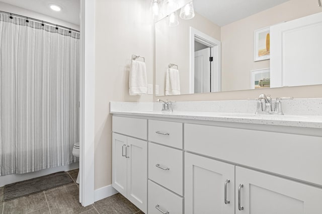 5068 Airlake Draw, Woodbury, MN 55129 - bathroom featuring double vanity, toilet, baseboards, curtained shower, and recessed lighting