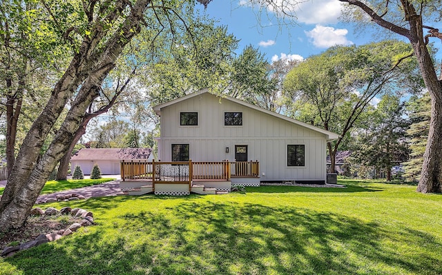 rear view of house featuring a wooden deck, a lawn, board and batten siding, and cooling unit