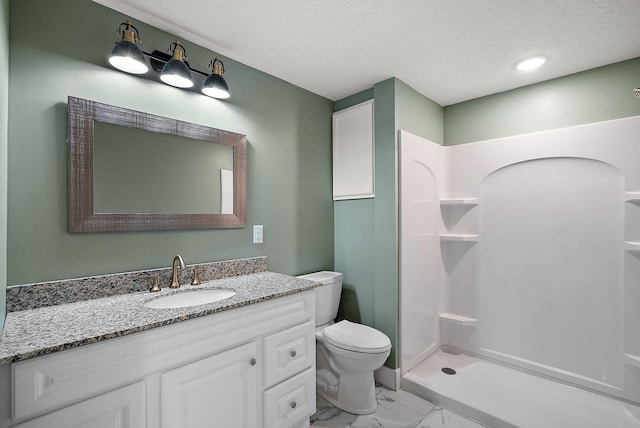 bathroom featuring marble finish flooring, a walk in shower, toilet, vanity, and a textured ceiling