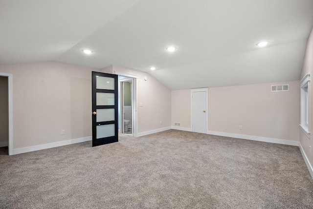 additional living space featuring vaulted ceiling, carpet, baseboards, and recessed lighting