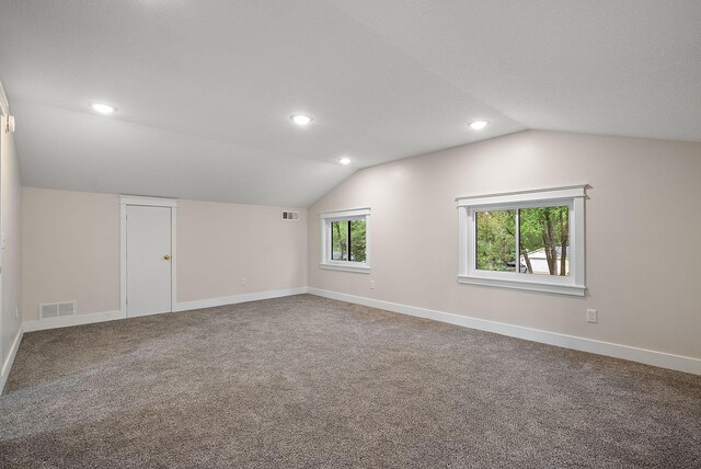 unfurnished room featuring lofted ceiling, recessed lighting, baseboards, and carpet floors