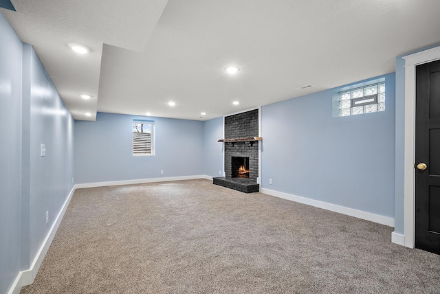 below grade area with carpet, a fireplace, recessed lighting, and baseboards