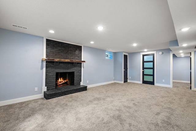 unfurnished living room with carpet, recessed lighting, a fireplace, and baseboards