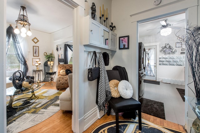 403 Spruce St, Fergus Falls, MN 56537 - entryway with light wood-type flooring, ceiling fan, and a chandelier