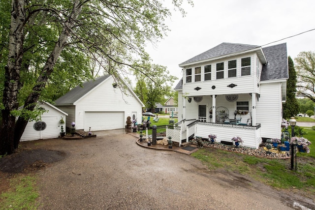403 Spruce St, Fergus Falls, MN 56537 - view of front of house with roof with shingles, an outbuilding, a garage, and covered porch