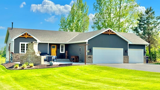 33401 Lakes Trl, Chisago Lake Twp, MN 55045 - view of front of home featuring an attached garage, asphalt driveway, a front yard, roof with shingles, and board and batten siding