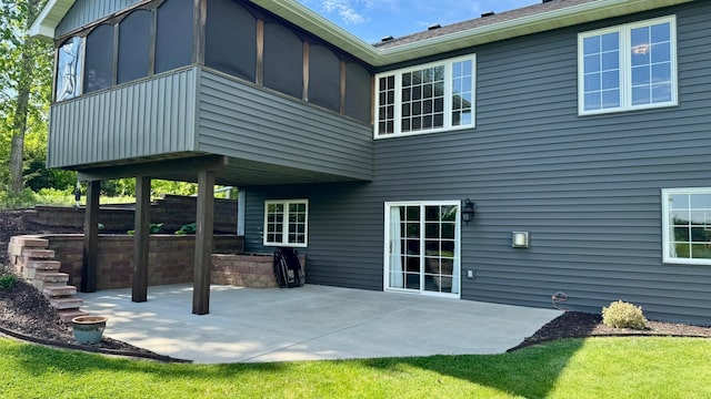 33401 Lakes Trl, Chisago Lake Twp, MN 55045 - back of property with a patio and a sunroom