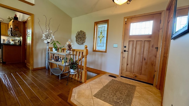 33401 Lakes Trl, Chisago Lake Twp, MN 55045 - foyer featuring healthy amount of natural light, vaulted ceiling, baseboards, and wood finished floors