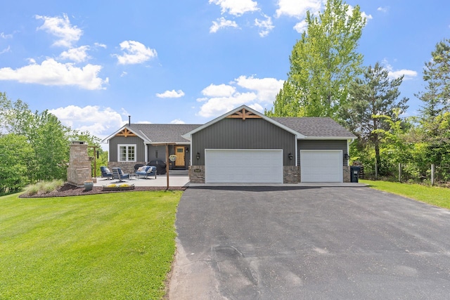 33401 Lakes Trl, Chisago Lake Twp, MN 55045 - view of front of home with a garage, a front yard, driveway, and stone siding