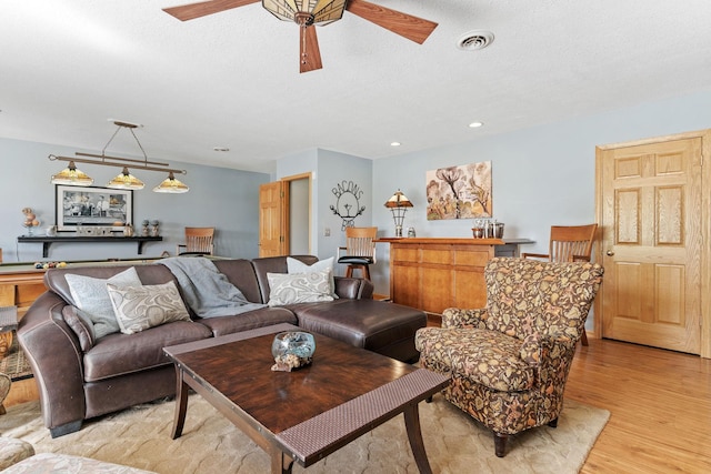 33401 Lakes Trl, Chisago Lake Twp, MN 55045 - living room featuring light wood-style flooring, a ceiling fan, and a textured ceiling
