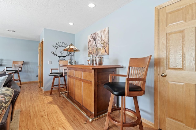 33401 Lakes Trl, Chisago Lake Twp, MN 55045 - indoor dry bar with light wood-style floors, baseboards, a textured ceiling, and recessed lighting
