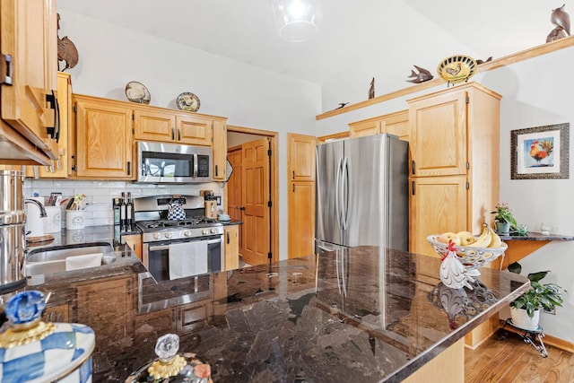 33401 Lakes Trl, Chisago Lake Twp, MN 55045 - kitchen featuring appliances with stainless steel finishes, a sink, backsplash, dark stone countertops, and light brown cabinetry