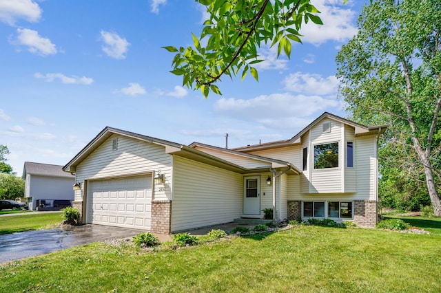 2191 Grimm Rd, Chaska, MN 55318 - tri-level home with brick siding, an attached garage, and a front yard