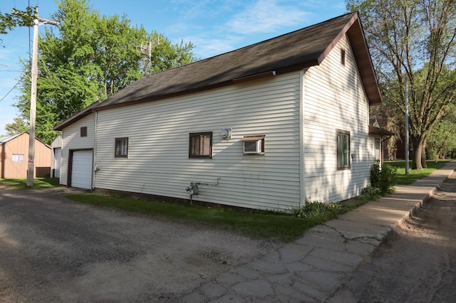 607 Wilson St, Downing, WI 54734 - view of side of property featuring a garage, an outdoor structure, and driveway