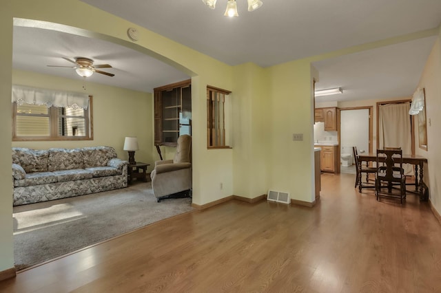 607 Wilson St, Downing, WI 54734 - living room with ceiling fan, wood finished floors, arched walkways, and baseboards