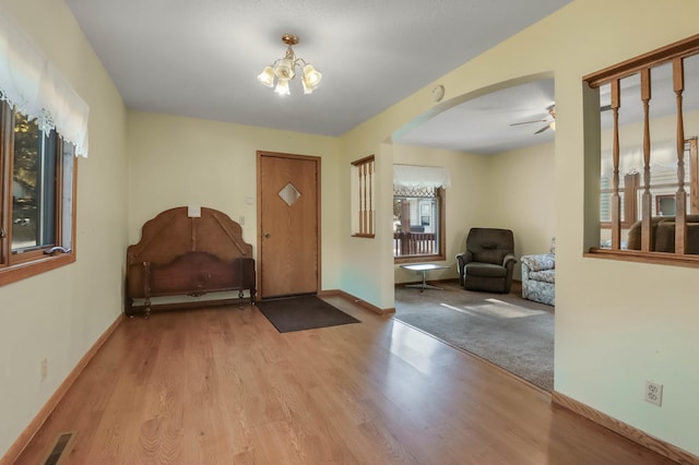 607 Wilson St, Downing, WI 54734 - foyer entrance with wood finished floors, ceiling fan, arched walkways, and a chandelier