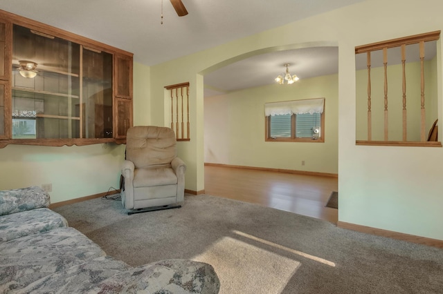607 Wilson St, Downing, WI 54734 - living room with arched walkways, carpet, a ceiling fan, a chandelier, and baseboards
